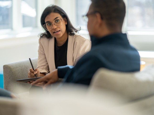 Female therapist speaks with male client