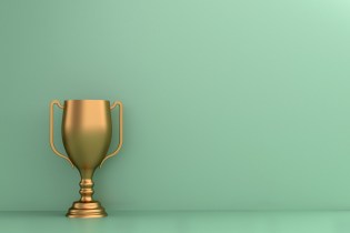 Yellow trophy against a mint green backdrop