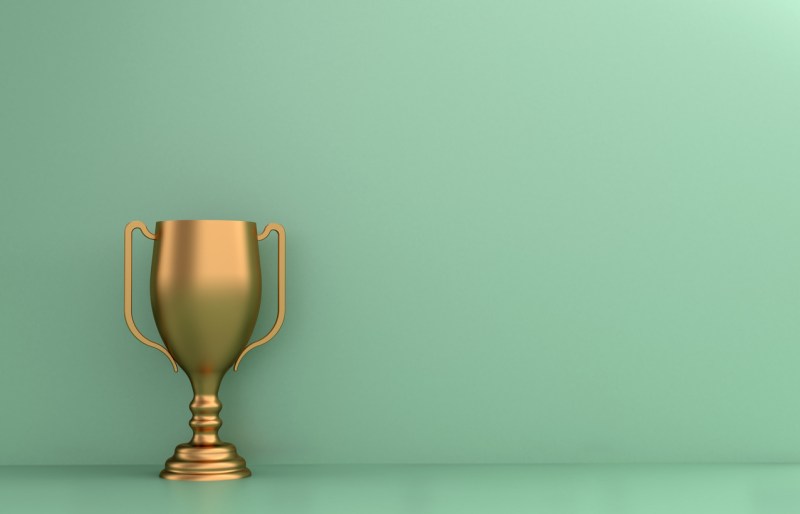 Yellow trophy against a mint green backdrop