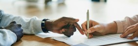 Two people discussing the terms of a collaborative practice agreement