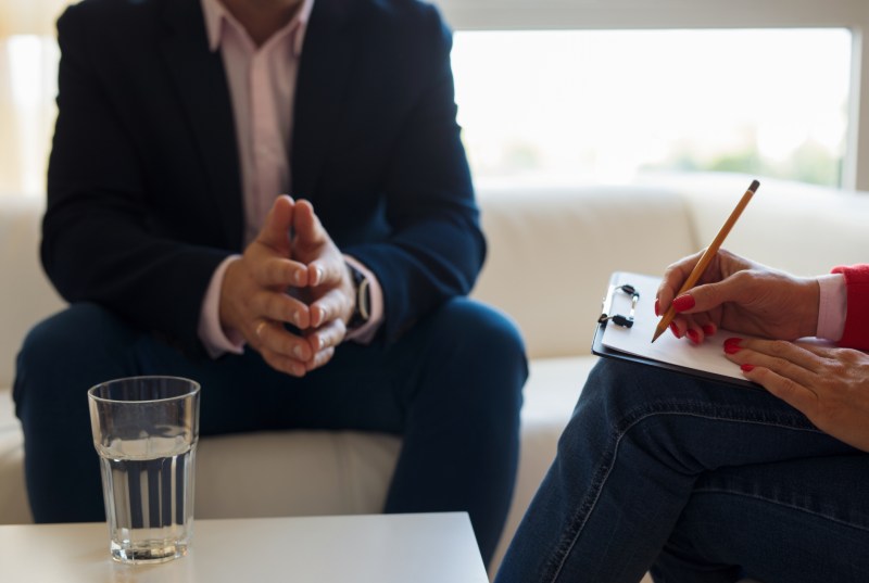 young man talking with a drug and alcohol counselor