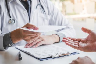 Nurse hiring manager holds a candidate's cover letter for a nursing job.