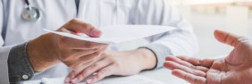 Nurse hiring manager holds a candidate's cover letter for a nursing job.