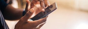 African American man scrolling through page on smartphone