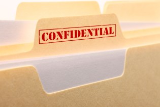 Manilla folder with a red Confidential stamp