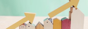 Row of wooden houses arranged from shortest to tallest with yellow arrows resting on top of them highlighting the progression of height.