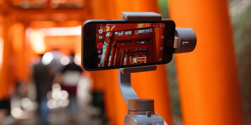 Smarphone on a tripod taking video of a local art installation