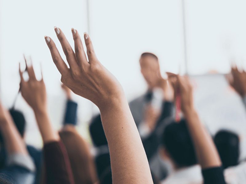 healthcare professionals raising hands asking questions