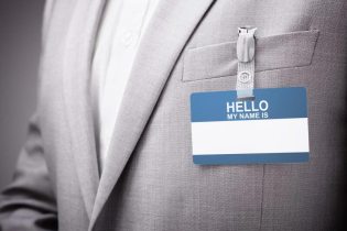 blank name tag on man's gray suit