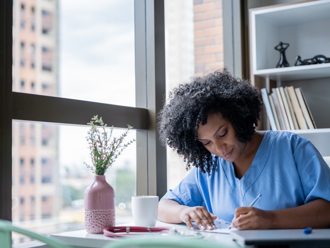 nurse writing on desk | best nurse entrepreneurs 