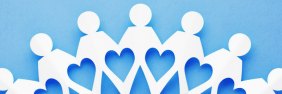 paper dolls on blue background making a heart