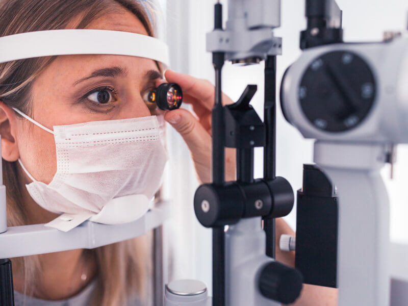 optometrist performing eye exam