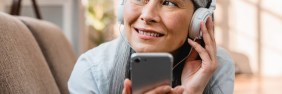woman listening to best podcasts for therapists on phone