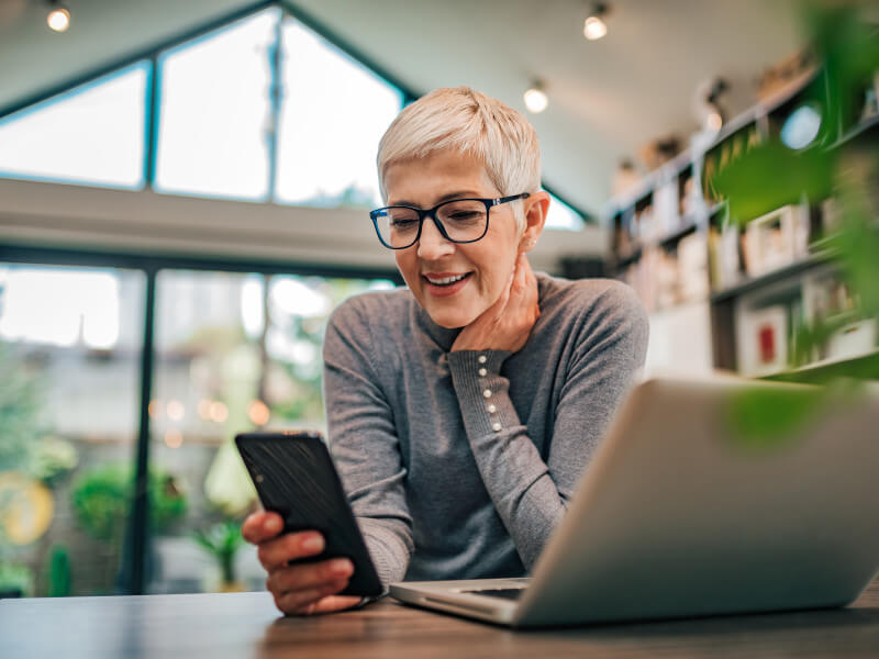 woman on phone looking at best nurse social media accounts