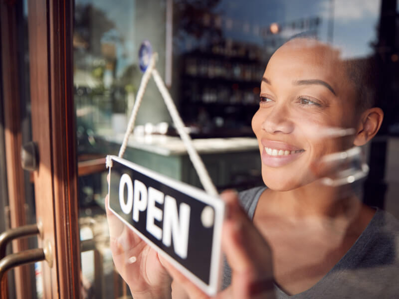 woman hitting her small business goals of opening business