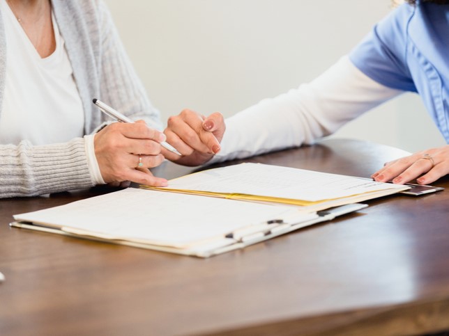 Dentist and woman filling out insurance info