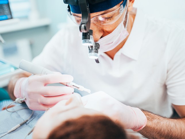 Dentist examining patient's mouth | Real Dental Board Complaint Example