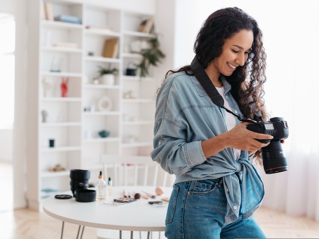 Woman checking her camera | General Liability Insurance Cost FAQ