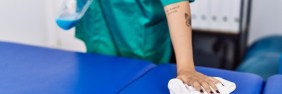 Woman wiping down physical therapy exam table | physical therapy malpractice story