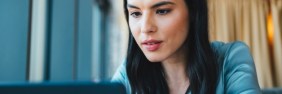 Woman searching on her laptop for Berxi insurance reviews