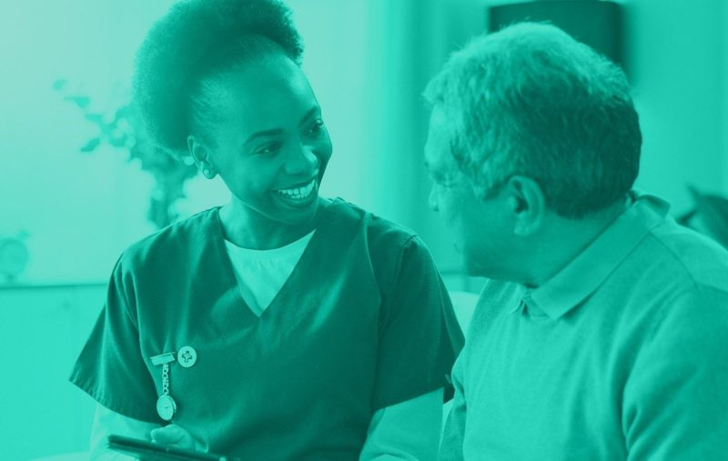 a nurse looking at a computer searching for the best nursing malpractice insurance