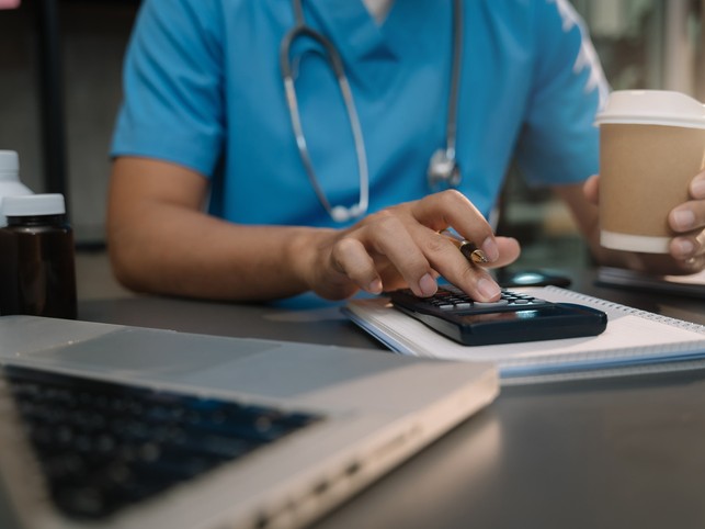 nurse calculating malpractice insurance cost 