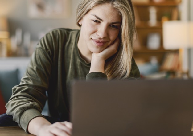 Woman researching insurance on her laptop 