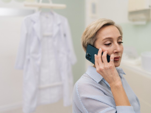 concerned female dentist talking on the phone 
