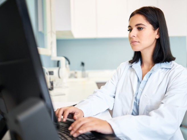 Female dentist working on computer 