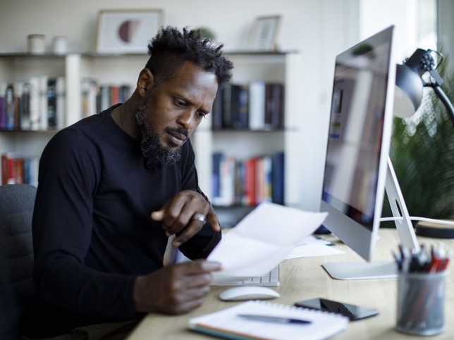 man at computer reviewing professional counselor liability insurance 