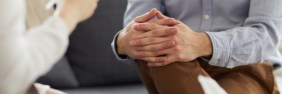 Man sitting with counselor | Counselor malpractice insurance cost