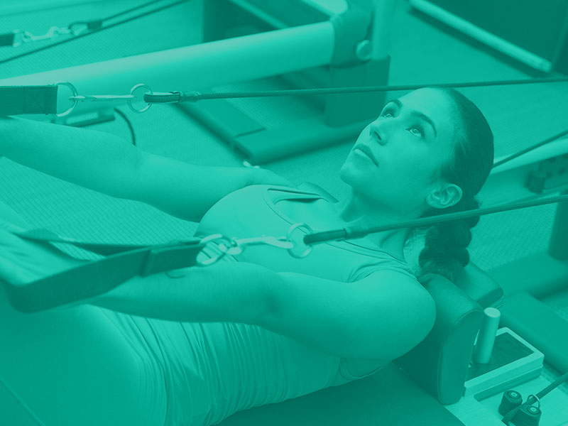 Woman working out on a pull down machine 