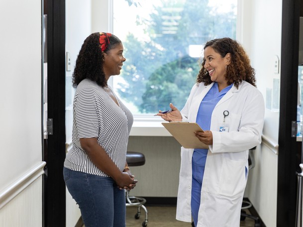 Female dentist talking to female patient in a dental office 