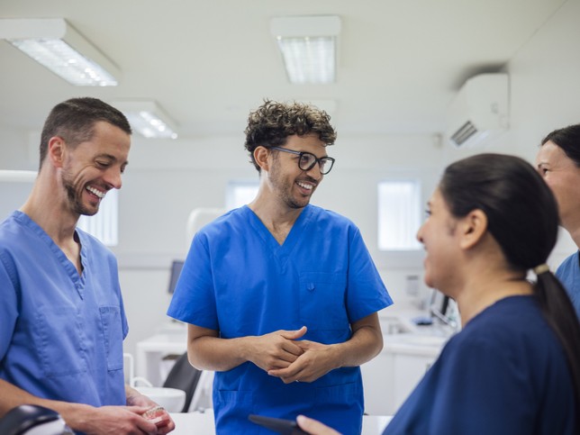 Group of dental professionals talking in the hallway of a dental practice 
