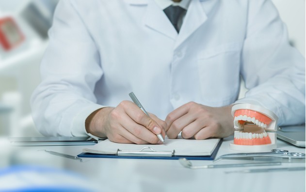 dentist filling out dental license papers