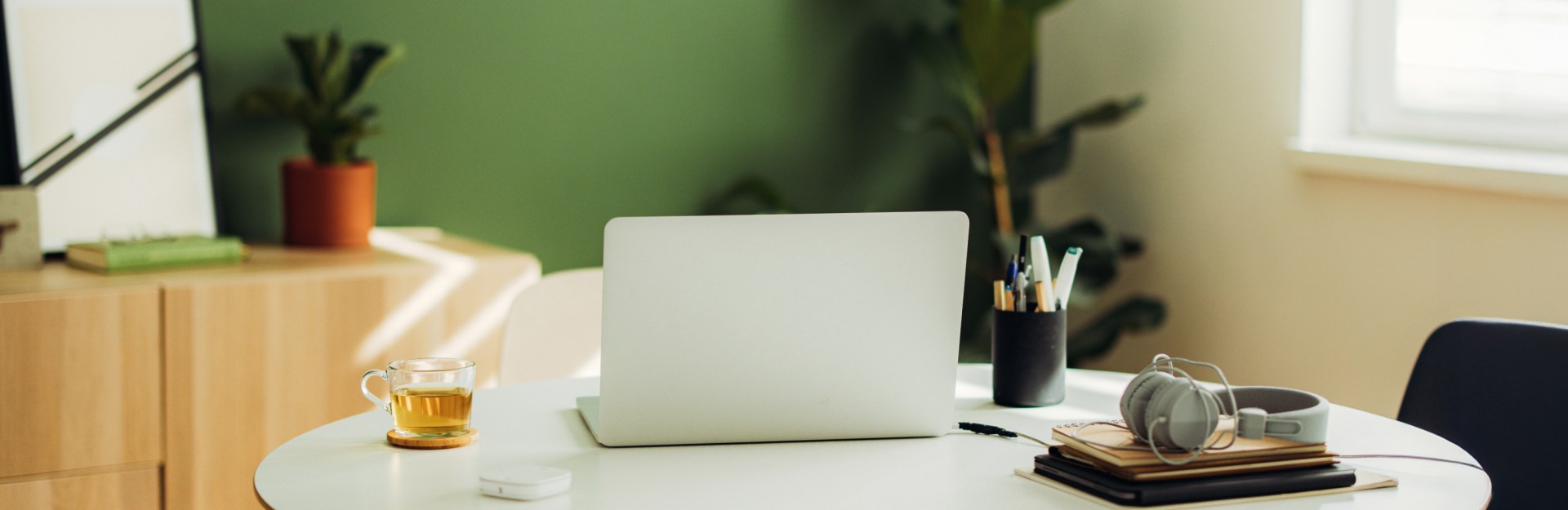 desk with laptop and tea cup on top of it | professional office insurance