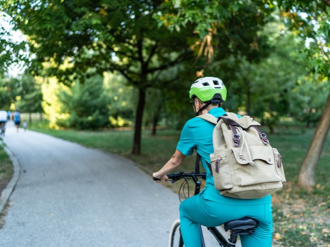 man in scrubs riding bike