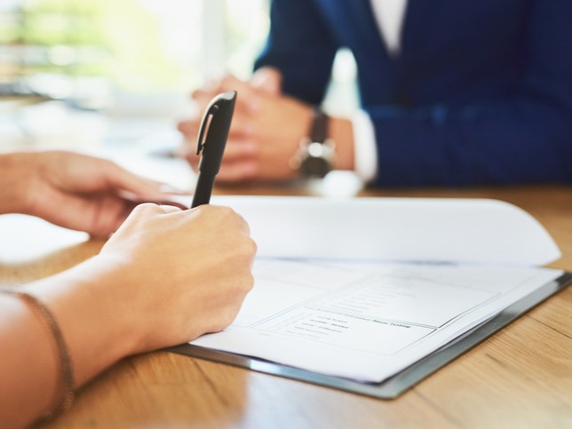 Nurse signing a malpractice lawsuit settlement 