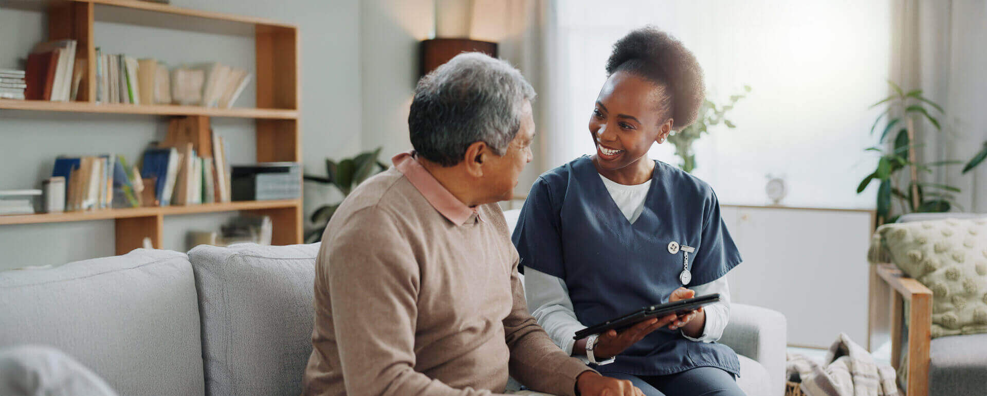Nurse working with patient on a tablet | nursing liability insurance