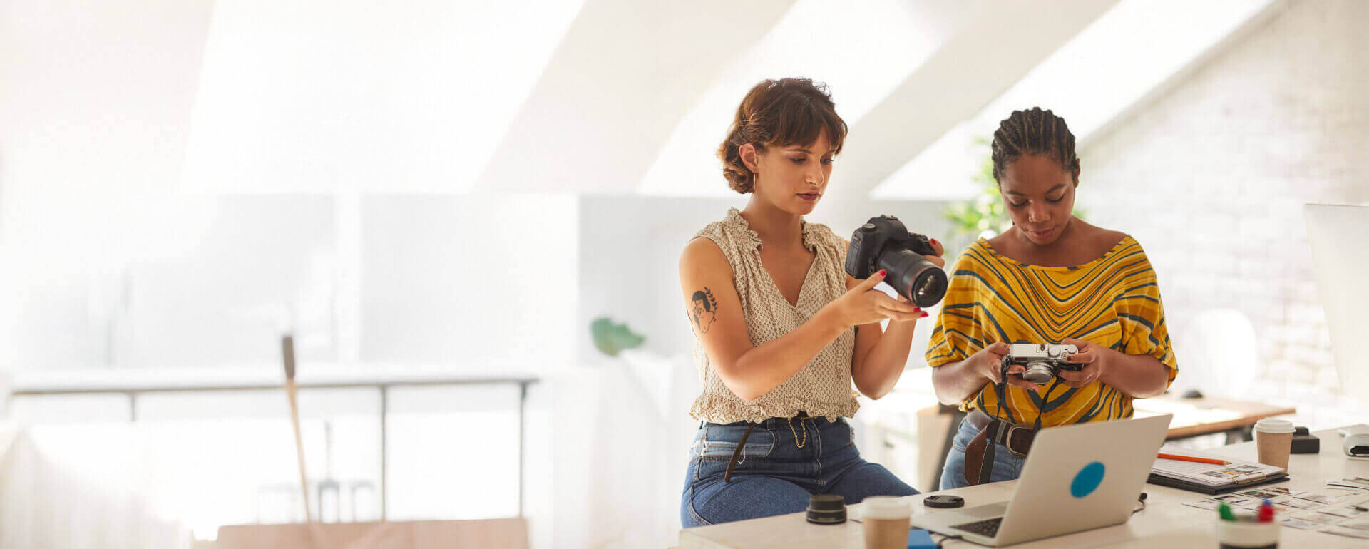 Photographers working with their cameras | general liability insurance for photographers