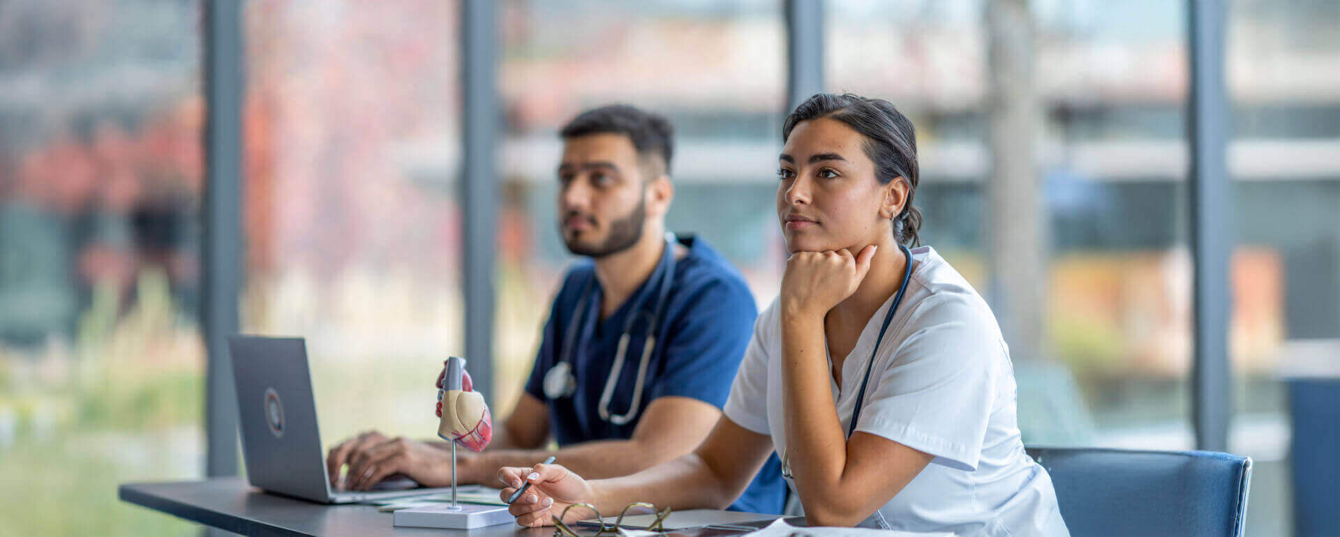 Nursing students in class taking notes | np student liability insurance