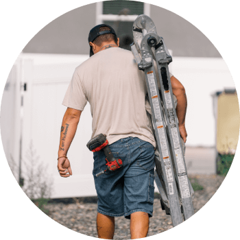 Handyman carrying ladder to a job 