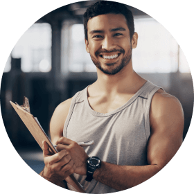 Personal trainer smiling with clipboard 