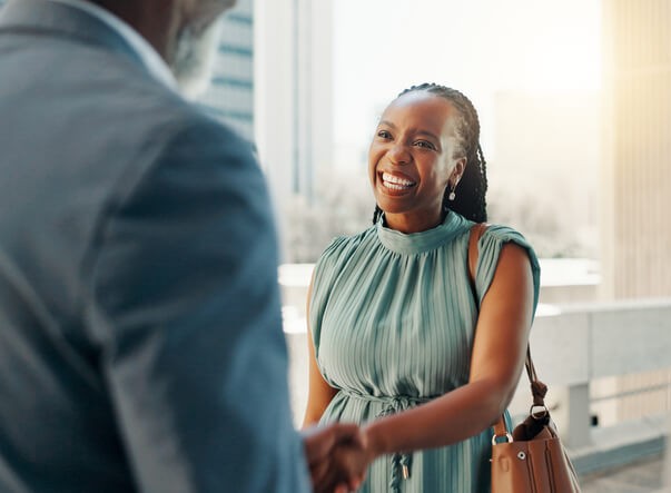 Small business owner shaking hand with client | What is small business insurance?