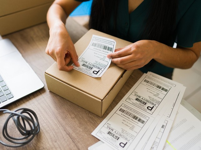 Small business owner preparing boxes for shipment 