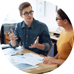 Tax preparer and client discussing tax documents 