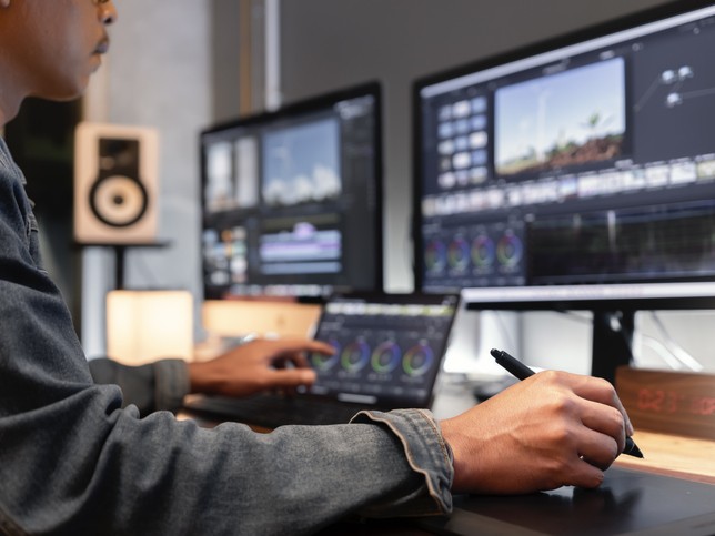 Video editor editing a video at his desk