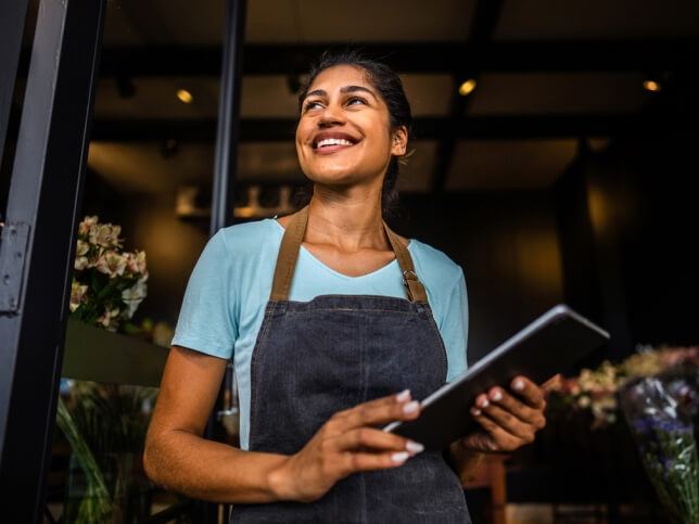 Business owner working on her tablet | Types of insurance for small business owners