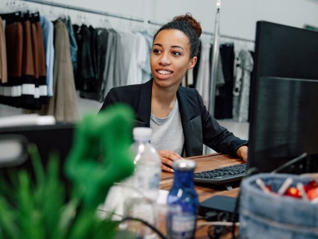 clothing store employee doing work on her computer