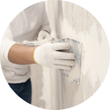 Drywall contractor working with spackle on drywall